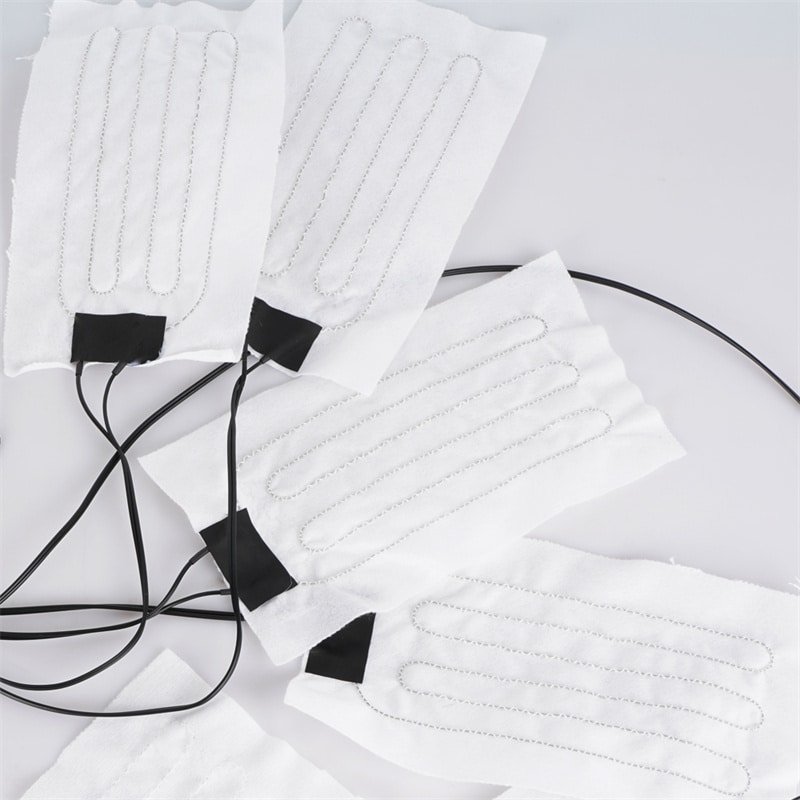 How wearable heating elements integrate into products: carbon fiber layers laminated between fabrics for even warmth in heated jackets, gloves, and apparel with waterproof protection