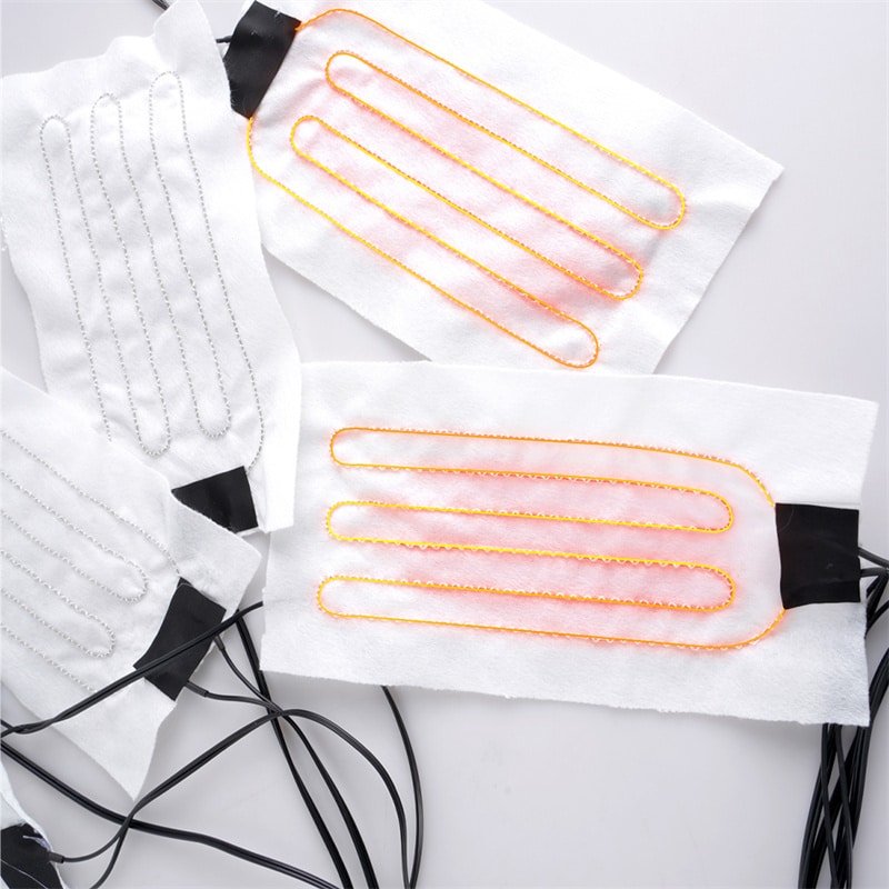 Cross-section of multi-layer wearable heating element showing heating conductor layer, flexible substrate, insulation, and protective coating for safe, washable heated clothing and apparel