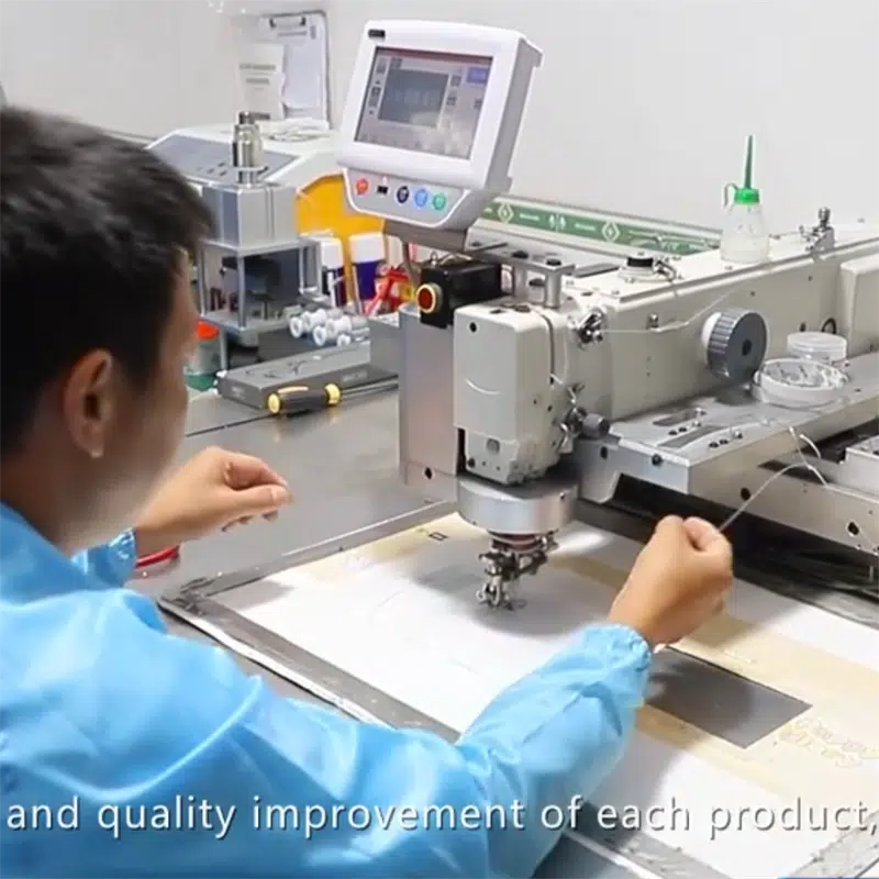 technician operating automated sewing machine to produce flexible heating elements for heated apparel