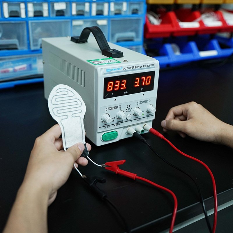 testing heated insole heating element with DC power supply showing electric heating performance and stability