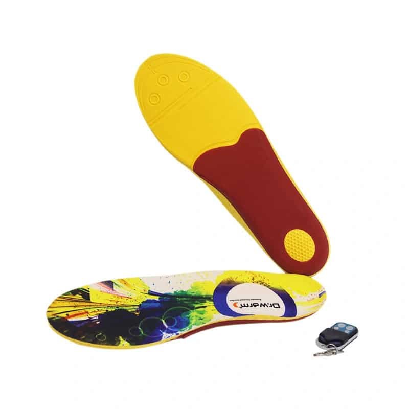 Heated insoles by Dr. Warm placed inside a pair of winter boots, ready for use in snow and ice.