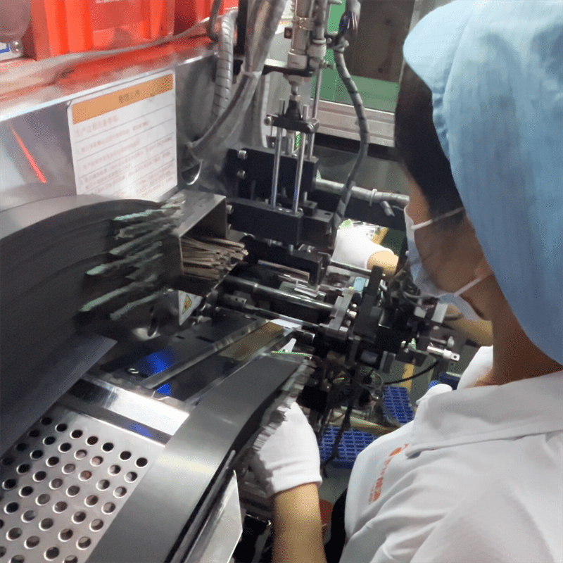 factory worker assembling lithium battery cells on production line OEM battery pack manufacturing for heated gloves heated apparel quality control process
