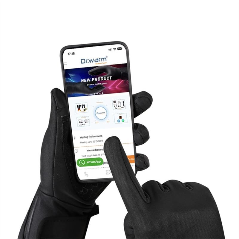 A rider using a smartphone and a bicycle GPS computer with their fingertips while wearing Dr.Warm heated gloves, showcasing seamless touchscreen operation.