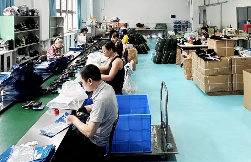Workers inspecting and packing heated products at the Dr. Warm factory before shipment
