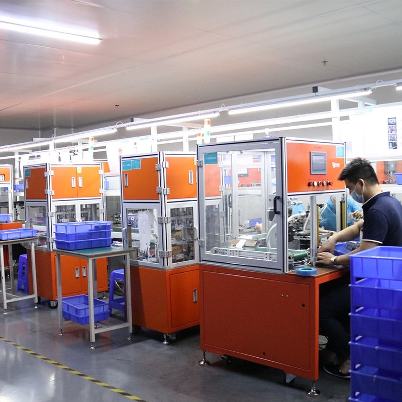 automated production line assembling electronics and heating components for heated apparel systems