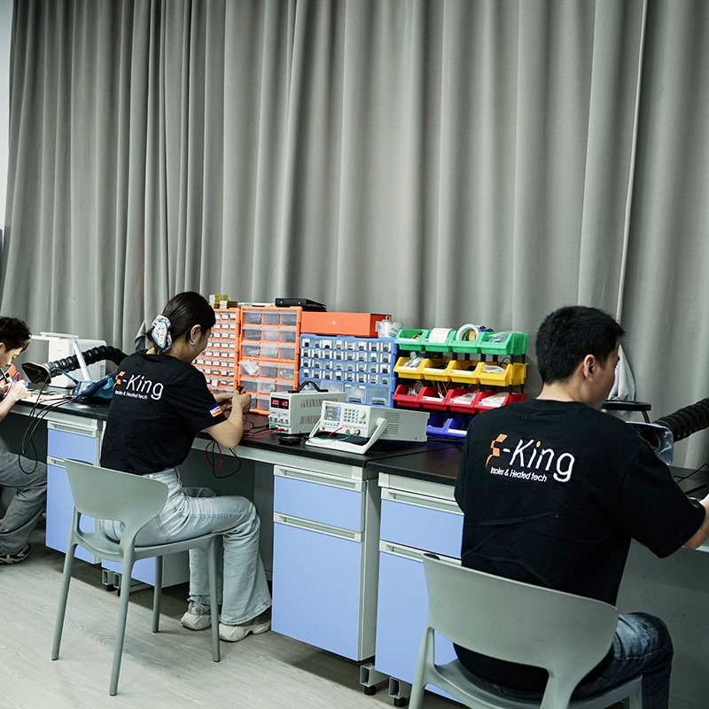 engineers developing custom PCBA controller design for heated clothing electronics and temperature control systems