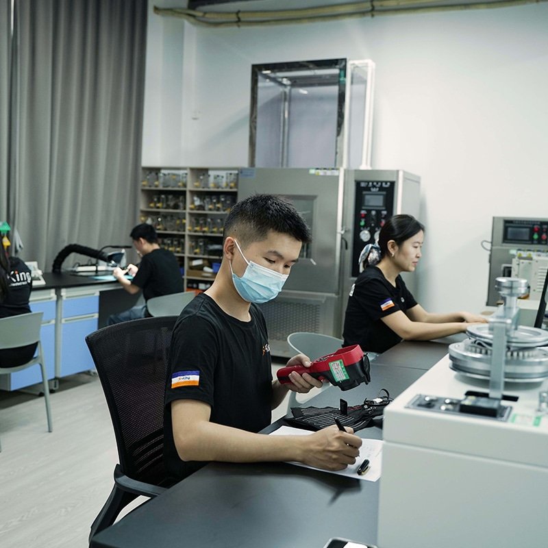 Engineer performing quality inspection and electronics testing for heated apparel PCBA and heated clothing controller system