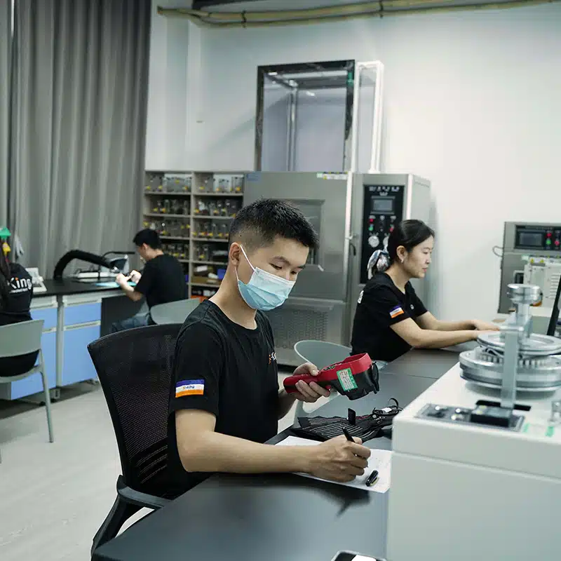 Engineer performing quality inspection and electronics testing for heated apparel PCBA and heated clothing controller system