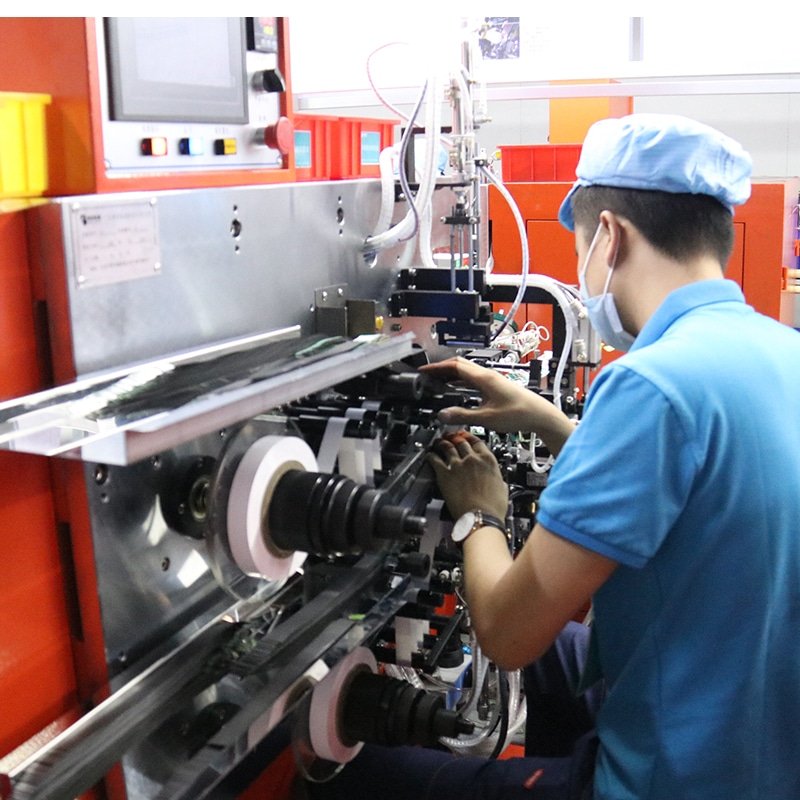 technician manufacturing heating elements for heated apparel including heated jackets gloves socks and insoles