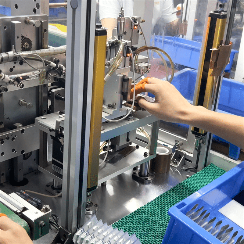 factory worker assembling lithium battery pack for heated gloves automated battery production line OEM heated apparel battery manufacturing process