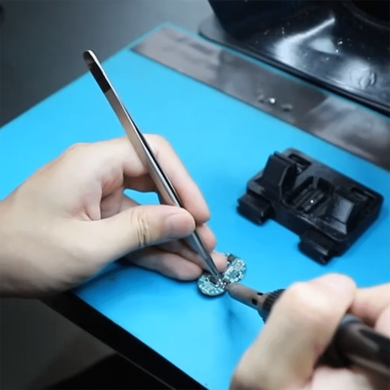 technician soldering PCBA components for heated apparel electronics and temperature control system during in-house PCBA assembly