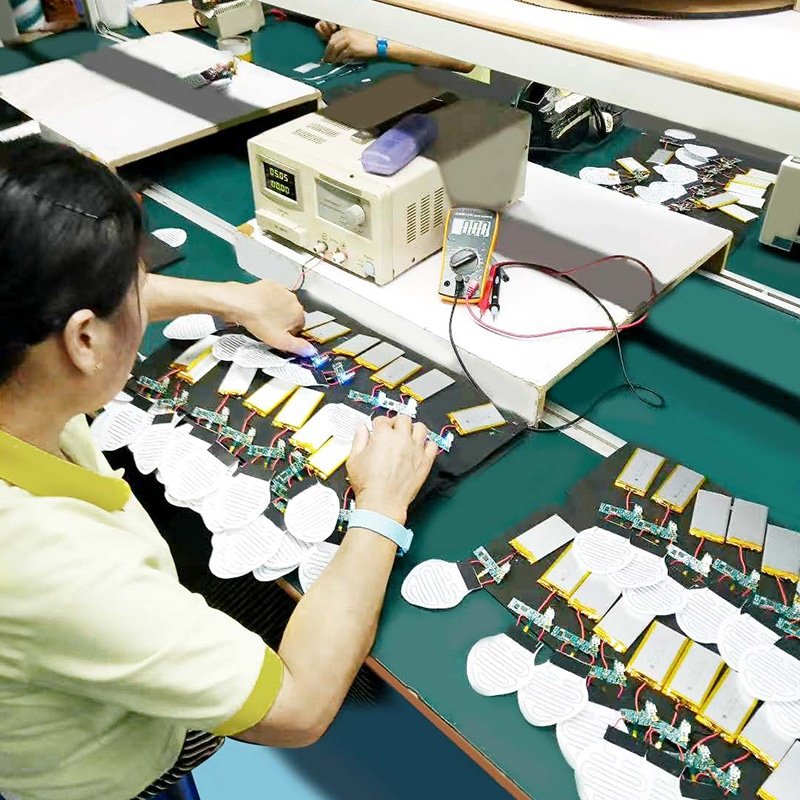 technician testing PCBA layout and battery powered heating modules for heated apparel electronics and heated wearables battery efficiency