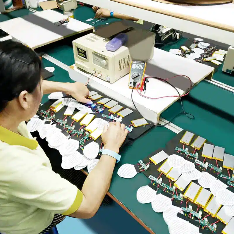 technician testing PCBA layout and battery powered heating modules for heated apparel electronics and heated wearables battery efficiency