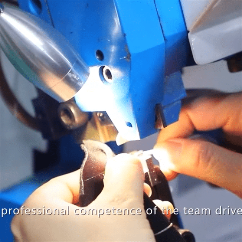 technician using ultrasonic welding machine to assemble heated apparel electronic components