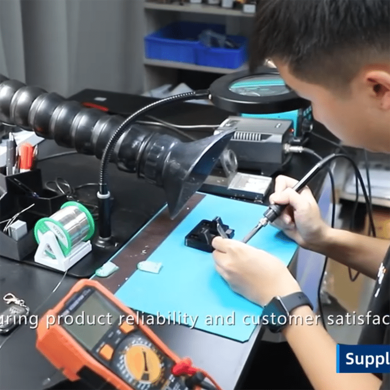 technician assembling and testing PCBA electronics for heated apparel temperature control systems during in-house heated product development