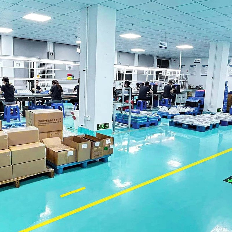 Clean and organized production workshop of custom heated gloves factory, showing assembly line and packaging area for wholesale electric heated gloves
